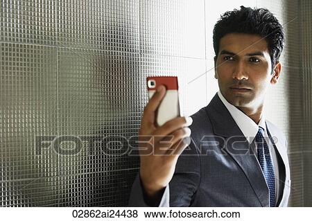 businessman taking photo of himself using mobile phone View Large Photo Image Stock Photo - businessman taking photo of himself using mobile phone. Fotosearch