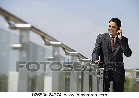 Picture - businessman talking on mobile phone. Fotosearch