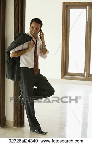 businessman talking on mobile phone, jacket over shoulder View Large Photo Image Stock Image - businessman talking on mobile phone, jacket over shoulder. Fotosearch