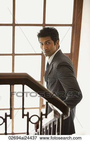 Stock Photo - businessman walking down stairs. Fotosearch