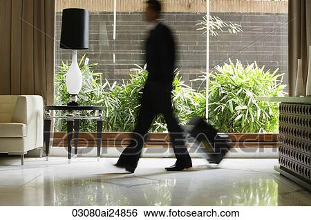 businessman walking through hotel lobby View Large Photo Image Stock Photograph - businessman walking through hotel lobby. Fotosearch
