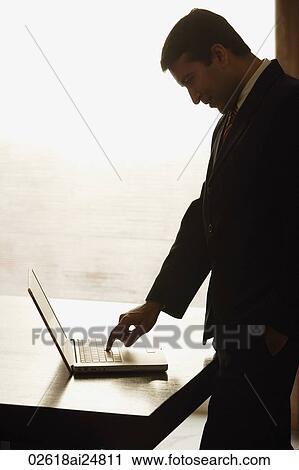 Stock Image - businessman working on laptop computer. Fotosearch
