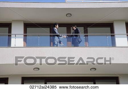 businessmen at balcony shaking hands View Large Photo Image Stock Photography - businessmen at balcony shaking hands. Fotosearch
