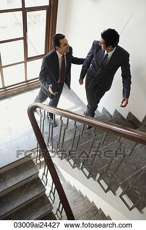 businessmen chatting while walking up the stairs View Large Photo Image Stock Photo - businessmen chatting while walking up the stairs. Fotosearch
