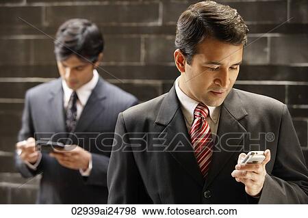 Stock Photo - businessmen, mobile phone. Fotosearch