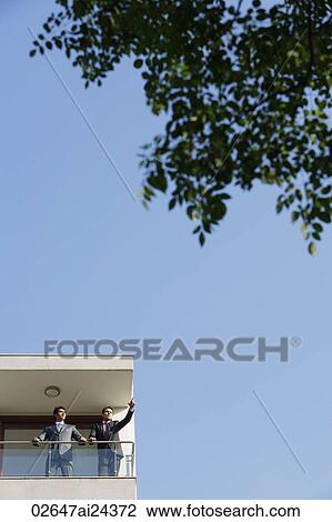 Stock Image - businessmen on balcony. Fotosearch