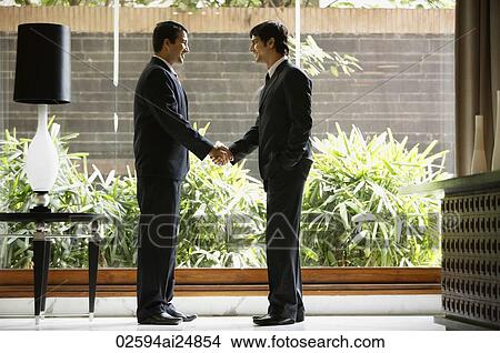 Picture - businessmen shaking hands. Fotosearch