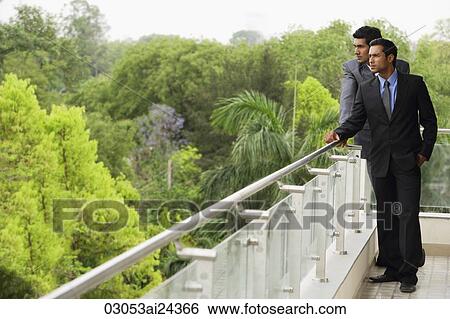 Stock Photograph - businessmen standing on balcony. Fotosearch