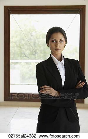 Businesswoman standing in front of window, arms folded View Large Photo Image Stock Image - Businesswoman standing in front of window, arms folded. Fotosearch