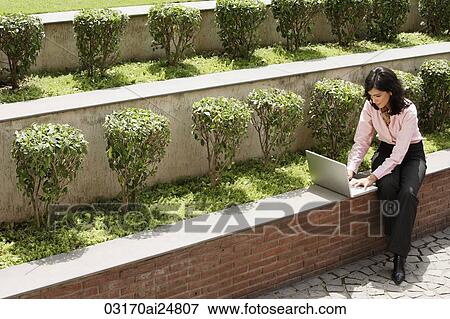 Stock Photo - businesswoman working outside, laptop computer. Fotosearch