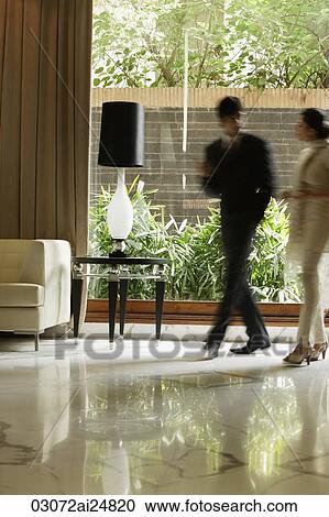 Stock Image - colleagues in hotel lobby. Fotosearch