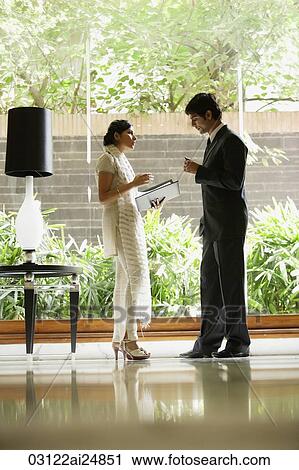 Stock Image - colleagues in hotel lobby. Fotosearch