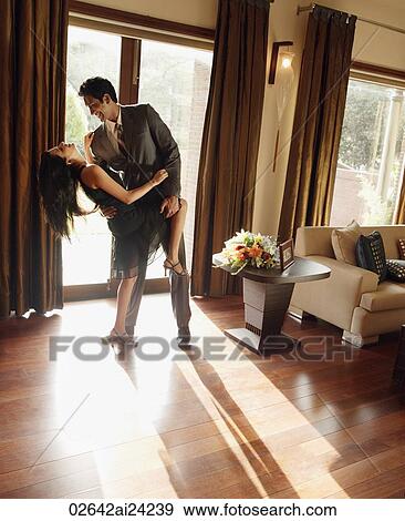 Stock Photo - couple dancing at home. Fotosearch