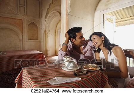 Picture - couple having coffee, chatting. Fotosearch