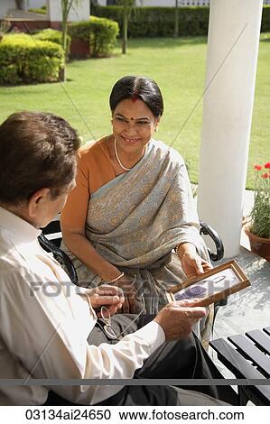 couple holding photograph, woman in bindi wearing sari View Large Photo Image Stock Image - couple holding photograph, woman in bindi wearing sari. Fotosearch