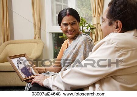 couple holding photograph, woman in bindi wearing sari View Large Photo Image Stock Photo - couple holding photograph, woman in bindi wearing sari. Fotosearch
