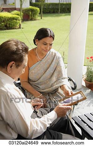 couple holding photograph, woman in bindi wearing sari View Large Photo Image Stock Photo - couple holding photograph, woman in bindi wearing sari. Fotosearch