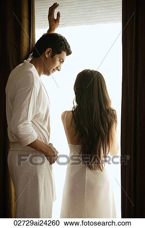 couple in front of bedroom window View Large Photo Image Stock Image - couple in front of bedroom window. Fotosearch