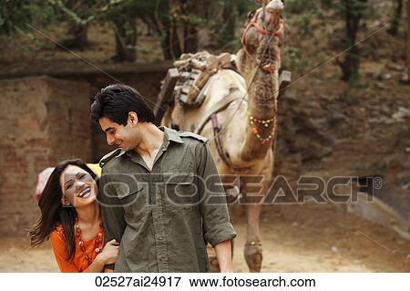 Stock Photo - couple in front of camel. Fotosearch