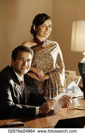 Picture - couple in office, woman in sari. Fotosearch