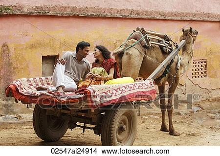 Picture - couple on camel cart. Fotosearch