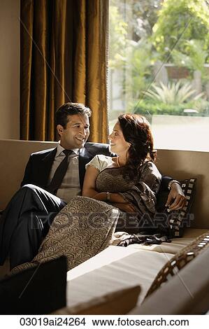 couple sitting close on couch View Large Photo Image Picture - couple sitting close on couch. Fotosearch