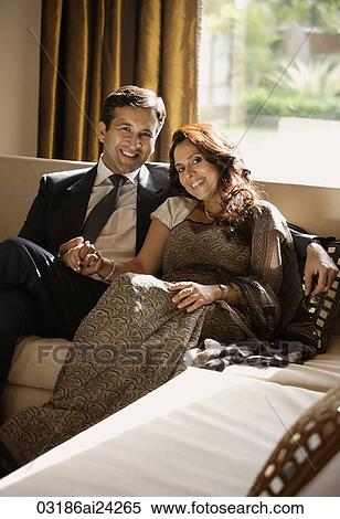 couple sitting on couch, holding hands View Large Photo Image Stock Photography - couple sitting on couch, holding hands. Fotosearch