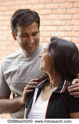 Stock Image - couple smiling at each other. Fotosearch
