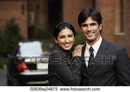 couple standing in front of car View Large Photo Image Stock Image - couple standing in front of car. Fotosearch