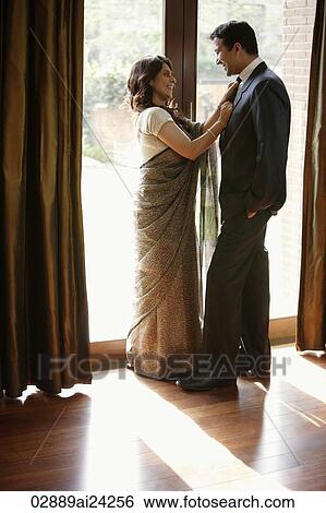 Stock Photograph - couple standing next to glass doors. Fotosearch