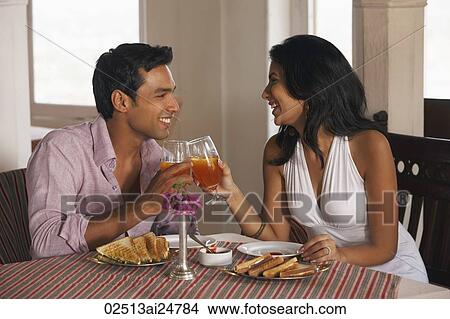 couple toasting in cafe View Large Photo Image Picture - couple toasting in cafe. Fotosearch