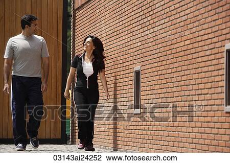 Stock Image - couple walking, in exercise clothing. Fotosearch