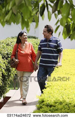 couple walking on path holding hands View Large Photo Image Stock Image - couple walking on path holding hands. Fotosearch