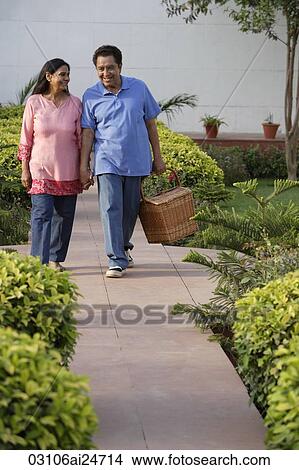 Picture - couple walking on path with picnic basket. Fotosearch