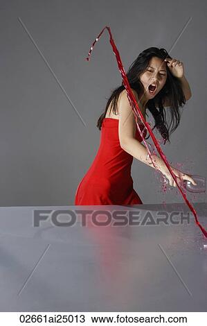 frustrated young lady in red, splashing wine on table View Large Photo Image Stock Image - frustrated young lady in red, splashing wine on table. Fotosearch