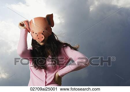 Stock Image - lady with pig mask. Fotosearch