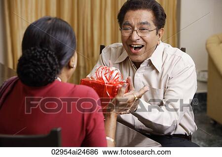 man giving woman gift View Large Photo Image Stock Photograph - man giving woman gift. Fotosearch
