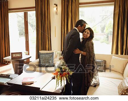 man kissing woman on cheek, flowers behind his back View Large Photo Image Stock Photography - man kissing woman on cheek, flowers behind his back. Fotosearch
