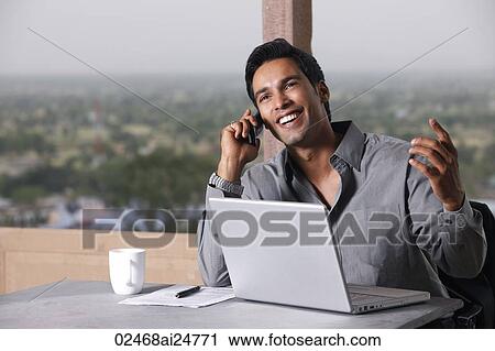 man on phone, working at laptop computer View Large Photo Image Stock Image - man on phone, working at laptop computer. Fotosearch