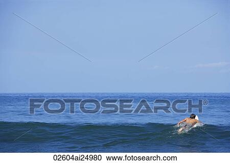 man on surf board, surfing out to sea View Large Photo Image Stock Image - man on surf board, surfing out to sea. Fotosearch