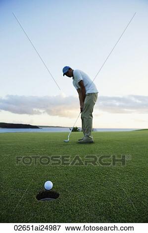 man playing golf during sunset View Large Photo Image Stock Photo - man playing golf during sunset. Fotosearch