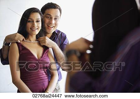 Stock Photo - man presenting woman with necklace. Fotosearch