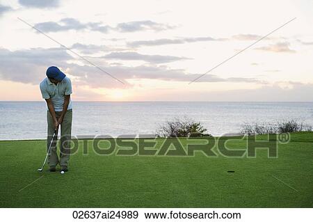 Stock Photo - man ready to hit golf ball. Fotosearch