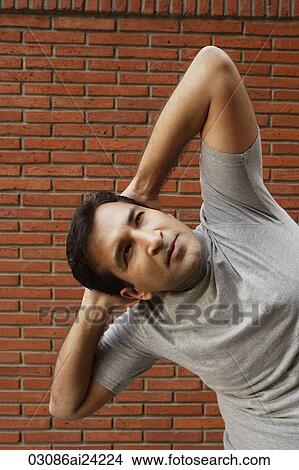 Picture - man stretching. Fotosearch