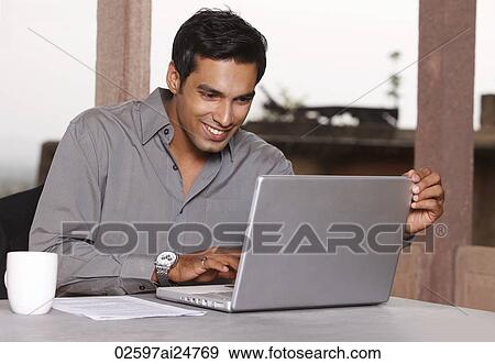 Stock Photo - man working at laptop computer. Fotosearch