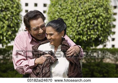 man wrapping shawl around woman View Large Photo Image Stock Image - man wrapping shawl around woman. Fotosearch