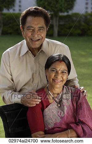 Stock Image - portrait of couple outdoors, woman wearing sari and bindi. Fotosearch