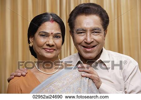 Stock Image - portrait of couple, woman in sari and bindi. Fotosearch