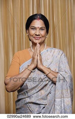 Stock Photo - portrait of woman in sari and bindi making namaste greeting gesture. Fotosearch