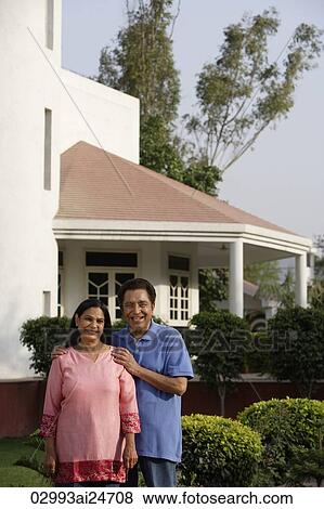 smiling couple standing in front of house View Large Photo Image Stock Photo - smiling couple standing in front of house. Fotosearch